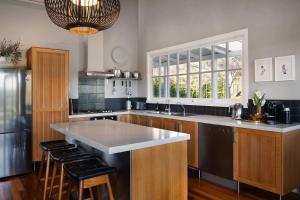 a kitchen with a large island in the middle at The Welcome Paddock in Hepburn +37 photos