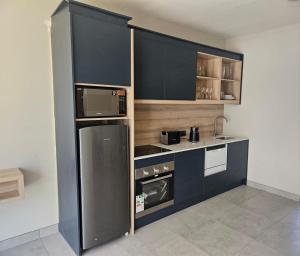 a small kitchen with a refrigerator and a microwave at PinotageLuxuryCollection 14 Bastmolen in Stellenbosch +8 photos