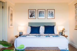 a bedroom with a large bed with blue pillows at Cockatoo Island Accommodation in Sydney +62 photos