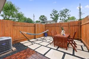 a patio with a hammock and a table and chairs at Contemporary Couples Getaway Near Austin Favorites - Loft 21 in Austin