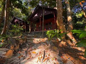 a wooden cabin in the woods with trees at Prey Apsara Bungalows in Koh Rong