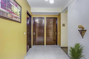 a hallway with wooden doors in a house at Townhouse Rumaisa in Noida