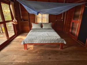 a bed in a room with a mosquito net at Prey Apsara Bungalows in Koh Rong +2 photos