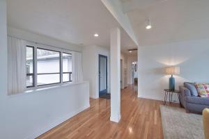 ein Wohnzimmer mit einer Couch und einem Fenster in der Unterkunft Vino Vista - Mid-Century Stunning Views w Deck in Dundee