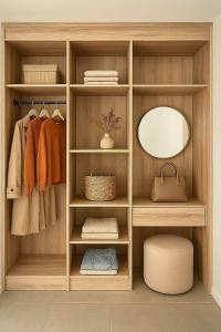 a wardrobe with a mirror and towels and a stool at PinotageLuxuryCollection 14 Bastmolen in Stellenbosch