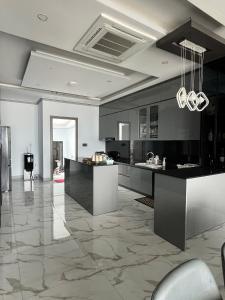 a large kitchen with black and white marble floors at Thiên long homestay in Kinh Dinh +15 photos