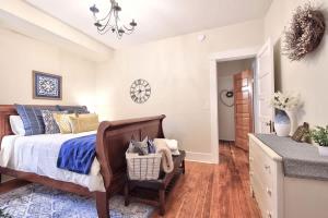 a bedroom with a bed with a chair and a table at 5th St Bungalow - Historic Charm Near 3rd St in McMinnville