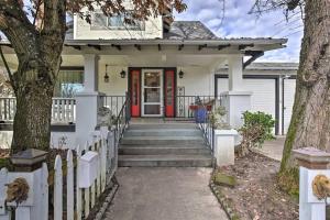 a white house with a red door and stairs at 5th St Bungalow - Historic Charm Near 3rd St in McMinnville