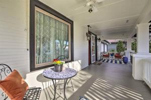 a porch of a home with a table and chairs at 5th St Bungalow - Historic Charm Near 3rd St in McMinnville