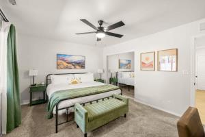 a bedroom with a bed and a ceiling fan at Mountain Cabin with Hot Tub in Flagstaff
