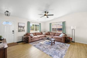 a living room with a couch and a ceiling fan at Mountain Cabin with Hot Tub in Flagstaff
