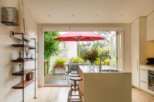 a kitchen with a counter with an umbrella at Cockatoo Island Accommodation in Sydney