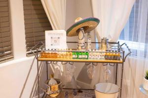 a shelf with bottles and a hat on it at 2Level Duplex with Jaccuzi-Gem in Chicago 4BD&3BA in Chicago +39 photos