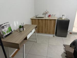 a kitchen with a table and a refrigerator at The Minimalist Suite in Kempton Park +5 photos