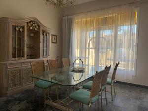a dining room with a glass table and chairs at 4 Bedroom Seaside Hurghada Escape in Hurghada