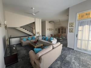 a living room with couches and a staircase at 4 Bedroom Seaside Hurghada Escape in Hurghada