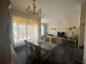 a dining room with a glass table and chairs at 4 Bedroom Seaside Hurghada Escape in Hurghada