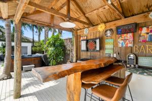 a large wooden table in a bar with chairs at Beach Escape Papamoa in Papamoa