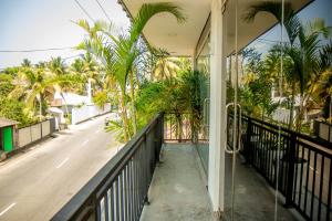 a balcony of a house with palm trees at Shan Resort in Gintota