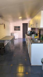 a kitchen with a counter and a table in it at Casa Agustina in Valdivia +4 photos