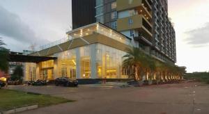 a large building with palm trees in a parking lot at The Vista Hotel By Satit Group in Sadao
