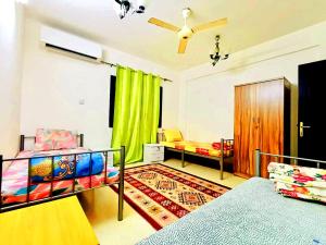 a bedroom with two bunk beds and a green curtain at Terhal guest house in Muscat
