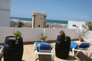 a patio with two chairs at Hostal Torre de Guzmán in Conil de la Frontera