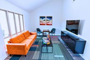 a living room with a couch and a tv at Plano 40 miles to Fifa Stadium Private Pool Lux Home by Vacation Your Way in Plano