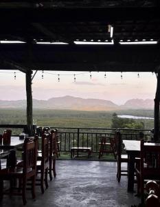 a restaurant with tables and chairs and a view at BaanPhutawanLanta in Ban Mo Nae