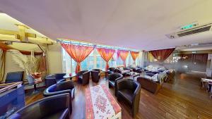 a living room with couches and tables and chairs at EXIGEHOME-Large houseboat with spa near Paris in Saint-Cloud