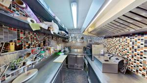 a large kitchen with a lot of dishes and sinks at EXIGEHOME-Large houseboat with spa near Paris in Saint-Cloud