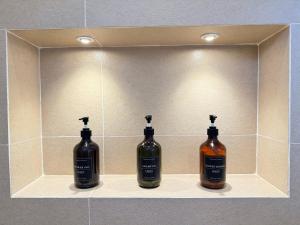 two bottles of alcohol on a shelf in a wall at Lily Mirissa in Mirissa +25 photos