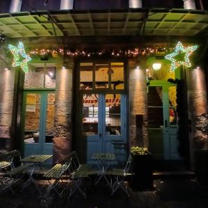 a front door of a restaurant with christmas lights at ISSA Lesvos in Mytilini