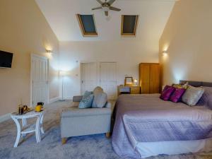 a bedroom with a bed and a couch and a chair at 1 bed in Cartmel 85499 in Cark