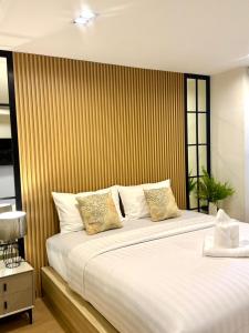 Ένα ή περισσότερα κρεβάτια σε δωμάτιο στο โรงแรมเดอะไนน์ พรีเมียร์