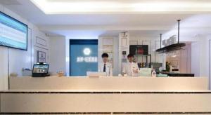 two men standing behind a counter in a kitchen at Xana Lite· Xi'an South Gate Yongningmen Subway Station in Xi'an
