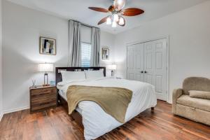 a bedroom with a bed with a ceiling fan and a chair at Stunning Home near Universal Kids Resort, Frisco in Little Elm