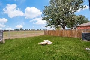 a bench in a yard next to a fence at Stunning Home near Universal Kids Resort, Frisco in Little Elm
