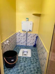 ein kleines Bad mit einem WC in der Ecke in der Unterkunft CR Residency in Tiruvannāmalai