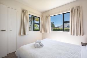 En eller flere senge i et værelse på Dragonfly Cottage