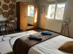 a bedroom with a large bed and a window at LA MAISON D'ULYSSE spa et détente in Anould +38 photos