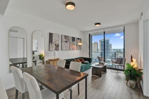 a dining room and living room with a table and chairs at Luxe Ventures Miami in Miami