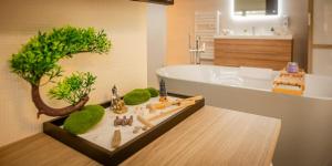 a bathroom with a bath tub and a bathroom with a tree at Zen, Proche Basel, Ambiance Japonaise & Calme in Saint-Louis +33 photos