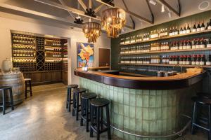 a bar with stools in a room with wine bottles at Mantons Creek Estate in Shoreham