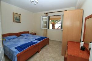 a bedroom with a bed and a window at Palman Othonoi House in Othonoi