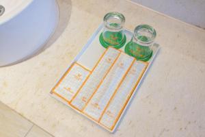 two glass jars sitting on a counter next to a sink at Vienna Hotel Guangdong Dongguan Chengnan Station in Dongguan