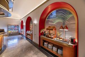 a kitchen with an archway and a counter with food at Beijing Tiananmen Square Manxin Hotel in Beijing