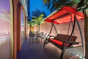 a swing on a porch with a table and chairs at Beijing Tiananmen Square Manxin Hotel in Beijing