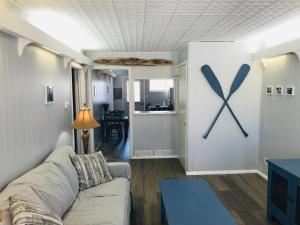 a living room with a couch and a large x on the wall at Lakeland House in Langley