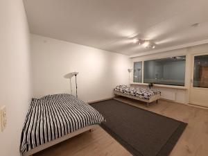a room with two beds and a window at Helsinki Matinkylä Apartment in Espoo